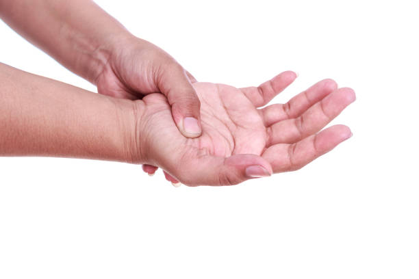 istock Close up woman's holding her hand isolated on white. Hand pain concept. 920143040