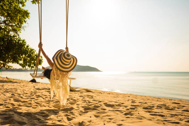 istock Woman at tropical swing 920143066