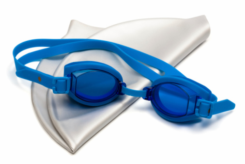 Glasses and cap for swimming on a white background