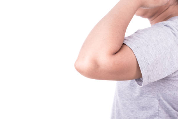 istock Close up woman's hand holding her elbow isolated on white. Elbow pain concept. 920156092