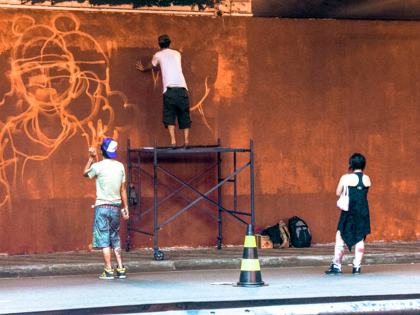 Sao Paulo, Brazil, Janeiro 27, 2007. Man makes a graffiti in the wall on Paulista Avenue tunnel, for the celebrations of Japanese Immigration to Brazil