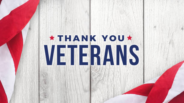 Thank You Veterans Text with American Flags Over Wood Background