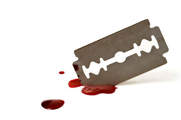 A sharp blade with spattered blood on white background stock photo