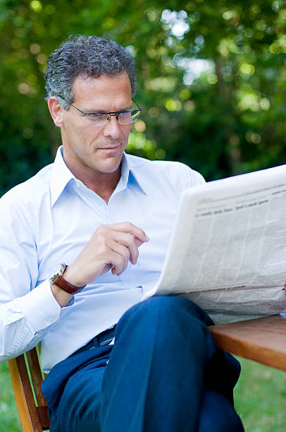 istock Mature man reading news 92018601