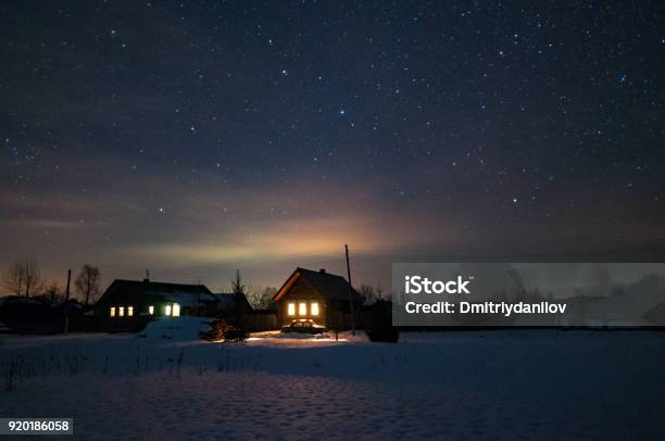 Houses In The Russian Village Winter Frosty Night Starry Sky Over The Roofs Of Houses Stock Photo - Download Image Now