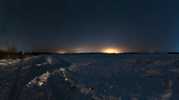 Photo of The road about field star night in Russia. Winter, frosty night.