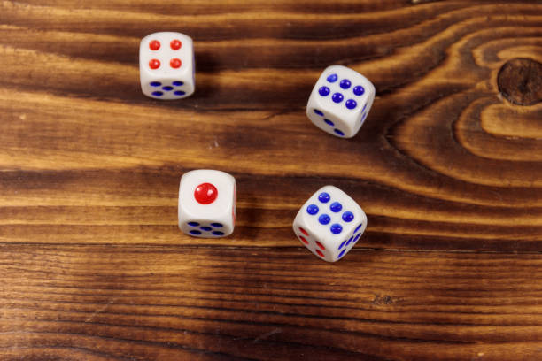 istock White dice on wooden table. Game of chance concept 920188806