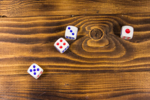 istock White dice on wooden table. Game of chance concept 920188820