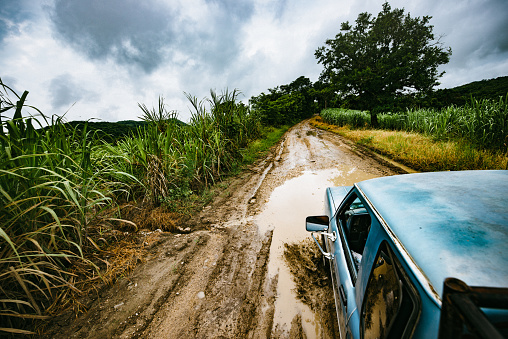 All terrain pick-up truck on muddy dirt road in Mexico