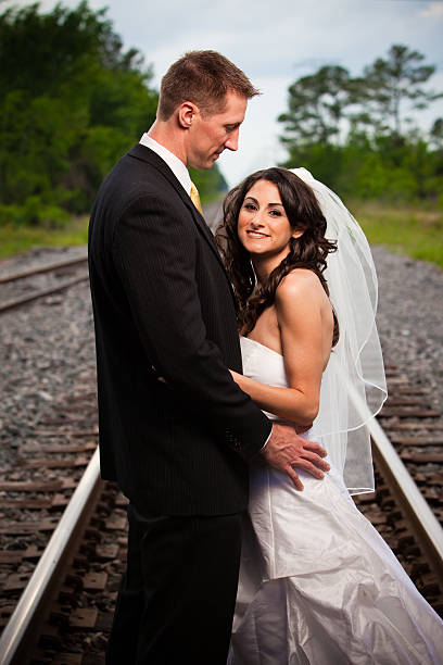 istock Groom looking at beautiful bride on railroad track 92018892