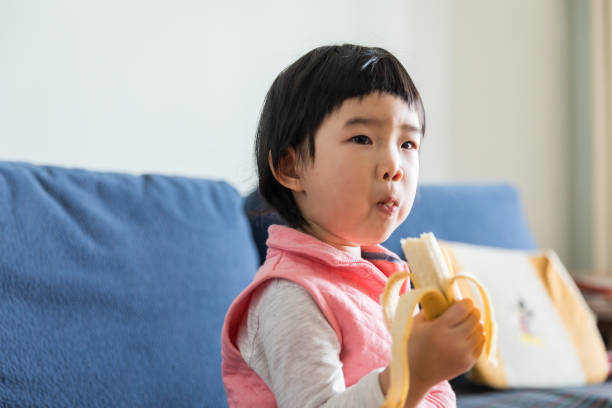 istock Resting at home kid eating bananas 920191660
