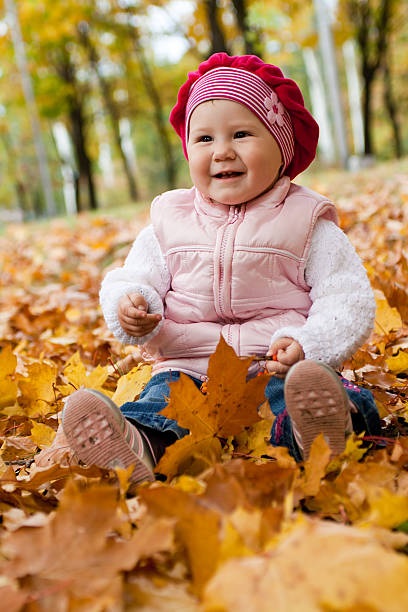 istock Smiley girl on yellow leaves 92019243