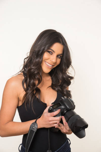 Smiling woman holding camera