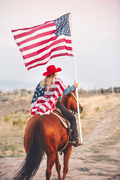 cowgirl pływające amerykańską flagą przed latem rodeo - flag bearer zdjęcia i obrazy z banku zdjęć