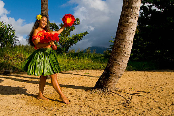 A hula dancer on a beach in Hawaii Hawaiian teenage girl dancing Hula on the beach in Kauai hula dancing stock pictures, royalty-free photos & images