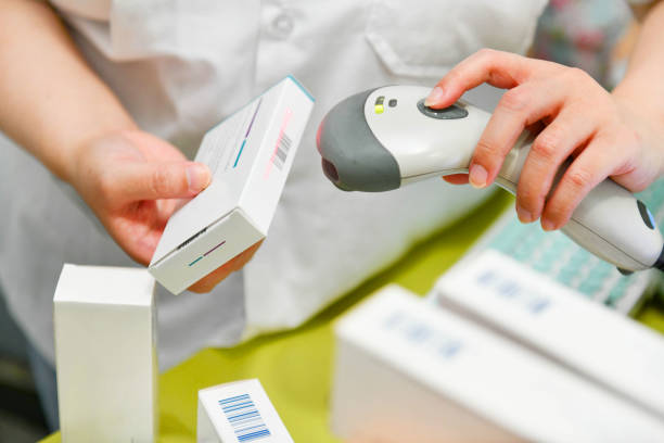 Pharmacist scanning barcode of medicine drug stock photo
