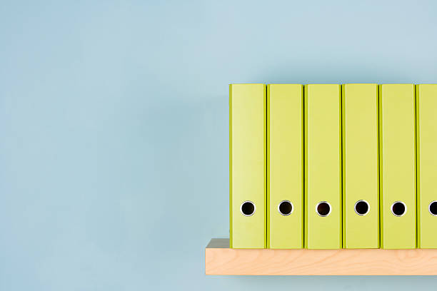 istock A variety of different green binders in a row on a shelf 92021913