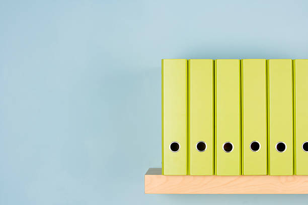 A variety of different green binders in a row on a shelf Row Of Green Ring Binders neat office stock pictures, royalty-free photos & images