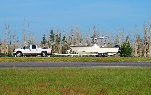 Boat trailers hitched to trucks