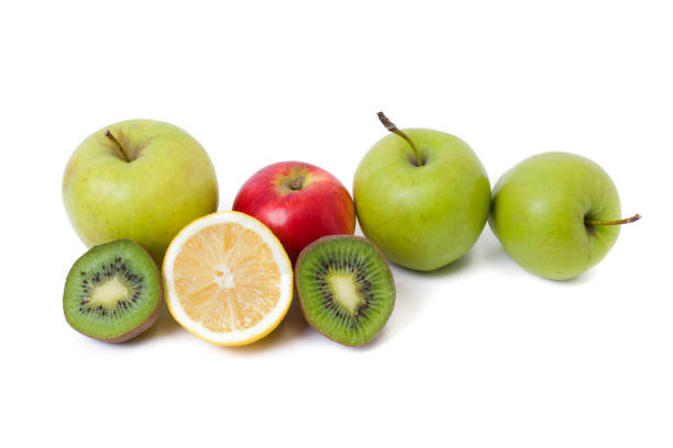 istock Fruits in a composition on a white background. Lemon with apples and kiwi on white background. Fruits with carrots on a white background. 920239052