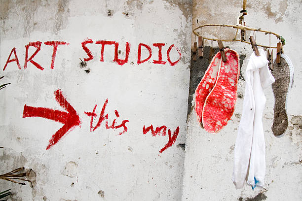 Barren art studio with clothes hanger and wall graffiti stock photo