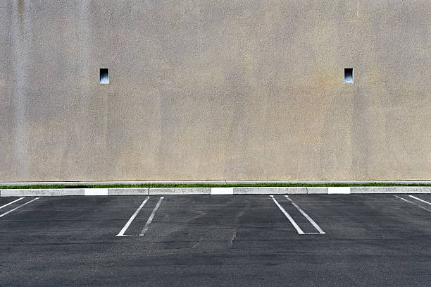 Parking spots against a blank wall stock photo