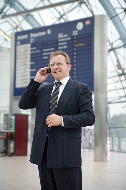 Businessman at airport, smiling face stock photo
