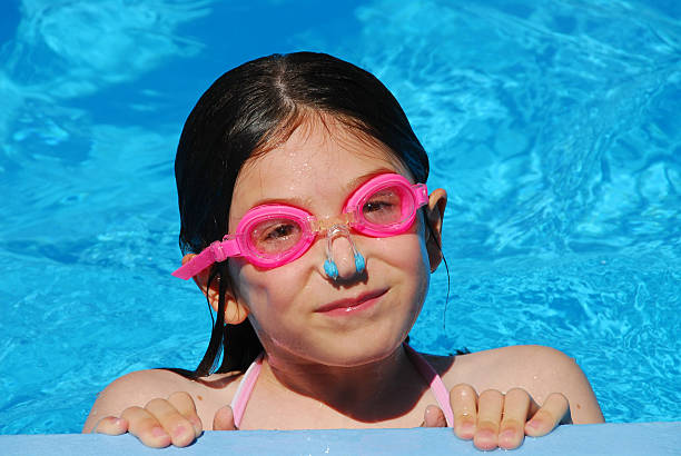 Happy girl having fun in swimming pool