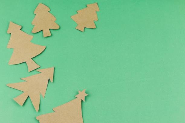istock hand made paper Christmas trees on green background with copy space. Christmas theme. 920260504