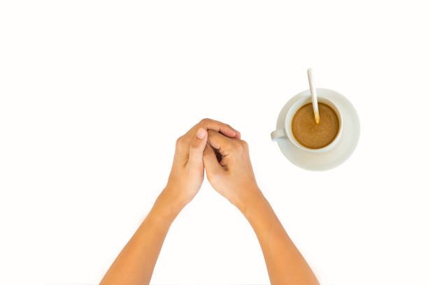hands with a cup of coffee isolated on white background. top view.