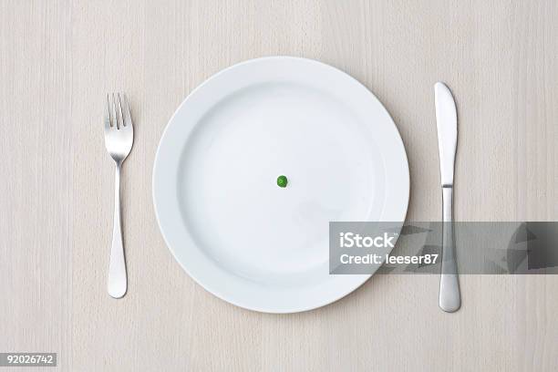 A Single Pea On A White Dinner Plate Stock Photo - Download Image Now - Bizarre, Color Image, Concepts