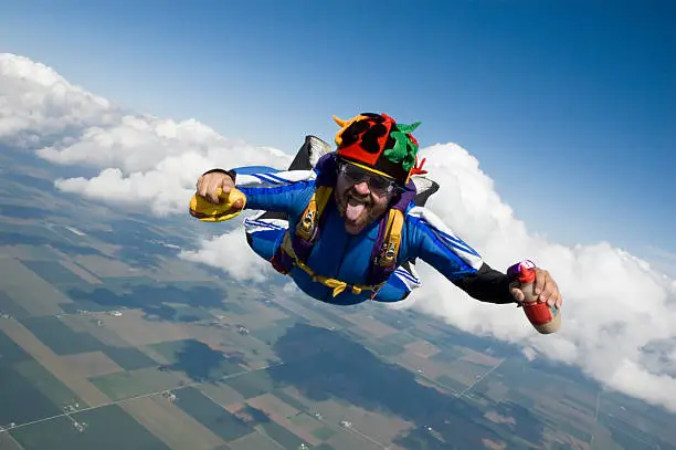 Skydiver with a hot dog and mustard in freefall.