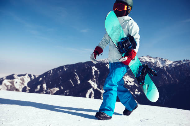 istock one snowboarder with snowboard walking on winter mountain peak 920268036