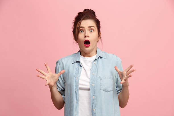 istock Beautiful woman looking suprised isolated on pink 920268128