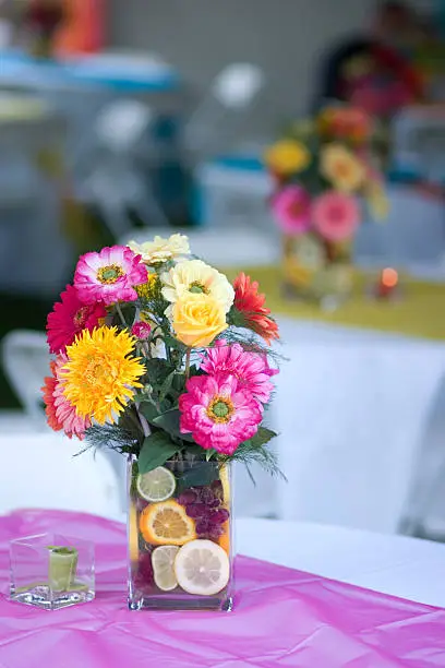 Photo of Table Decoration of Colorful Flower Bouquet and Fruit in Vase
