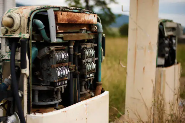 Rusted old fuel pump at the front of an abandoned fuel station.