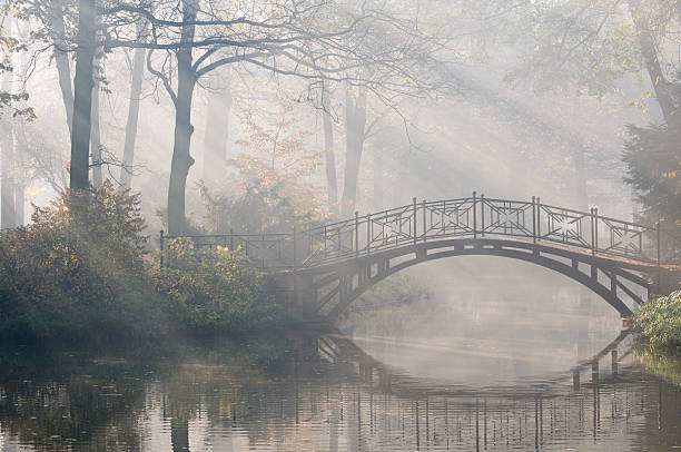 istock Sun rays on an old bridge over water in a park in autumn 92027500