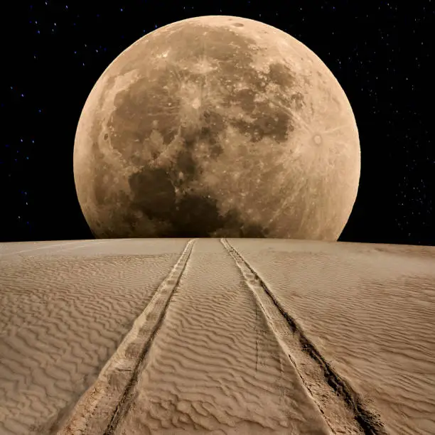 Photo of Tire Track on Desert at Supermoon Night