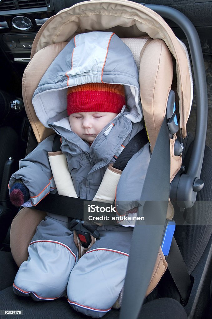 Child sleeping in safety seat  6-11 Months Stock Photo