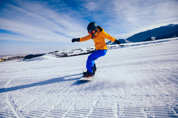 istock one woman snowboarder snowboarding in winter mountains 920291872