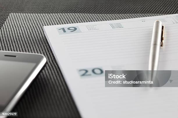 Closeup On An Open Agenda And Modern Smart Phone Stock Photo - Download Image Now - Ballpoint Pen, Black Color, Blank
