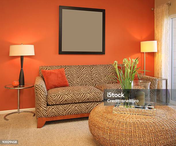 Modern Living Room Furniture Placed Before An Orange Wall Stock Photo - Download Image Now