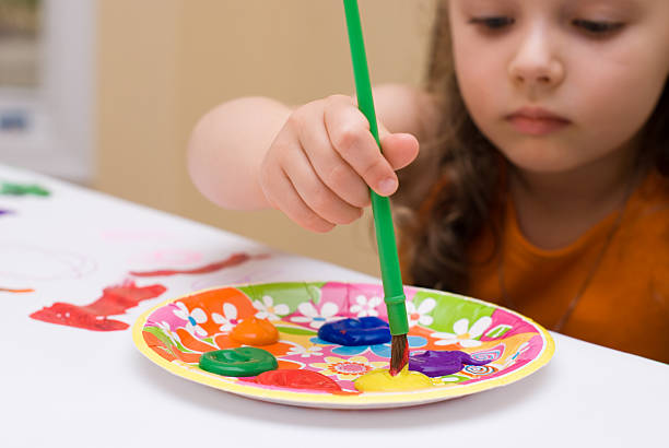 Young girl painting stock photo