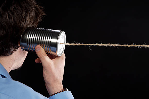 istock Man listening to tin can telephone 92029887