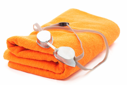 bath towel and swimming glasses isolated on white (shallow DOF);