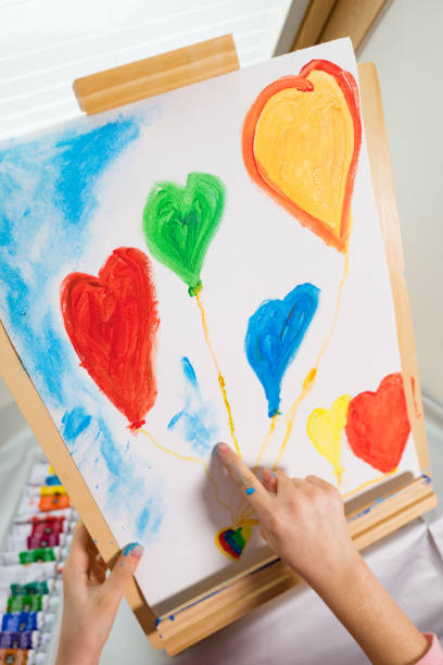 istock Painting a picture with hearts using hands 920312250