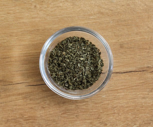 istock Glass bowl with fresh coriander herbs spice on wooden background 920326780