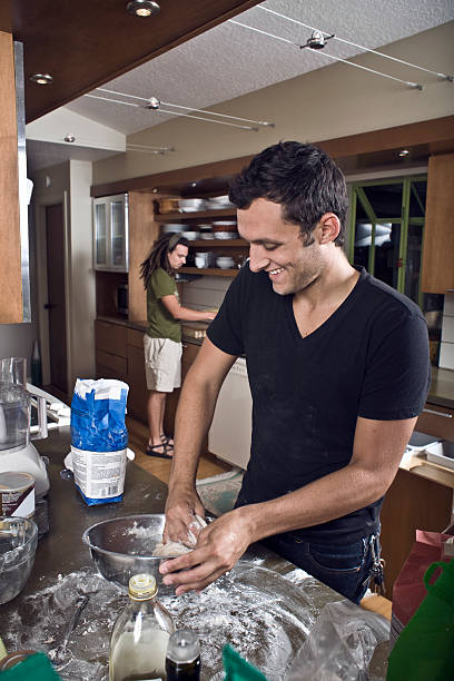 Young man making bread stock photo