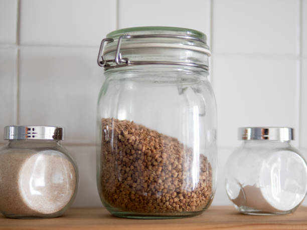 istock Buckwheat on sacking. Buckwheat in a clay cup on sackcloth. Laconic composition. Groats need for healthy eating and dieting. Pottery combines the color of buckwheat. Added warm tone. 920329210