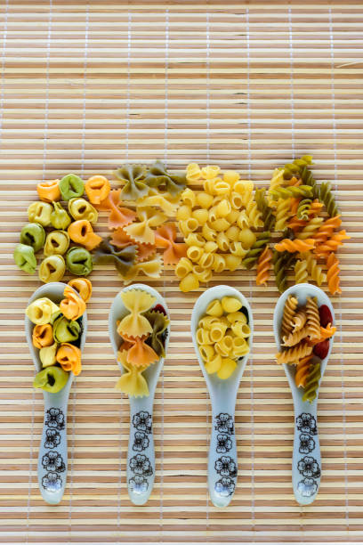 istock Pasta in porcelain spoons on bamboo 920329396